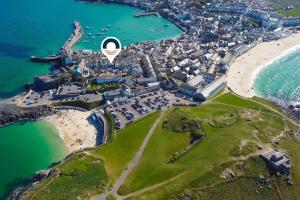 an aerial view of a town next to the ocean at Opechee in St Ives