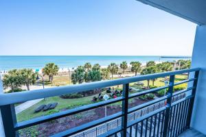 a balcony with a view of the beach and the ocean at Low Floor,Direct Oceanfront,Heated Pool,Boardwalk! in Myrtle Beach