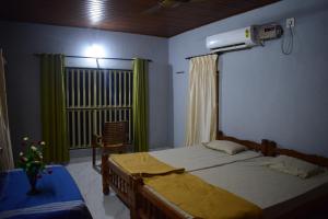 מיטה או מיטות בחדר ב-Delta Hospitality - Beach house cottages Hoode