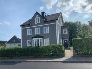a large gray house with a black roof at Good cheap apartment in a central location in Borås