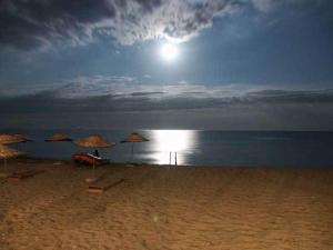 a beach with umbrellas on the sand and the ocean at Silivri Park Hotel in Silivri