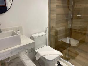 a bathroom with a toilet and a sink and a shower at Beautiful Accommodation - #Unity Flats Cabo Branco in João Pessoa