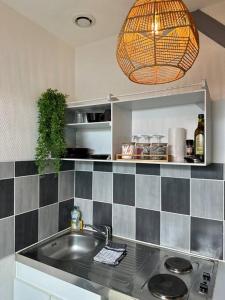 a kitchen with a sink and a pendant light at Studio proche Gare in Bourg-en-Bresse