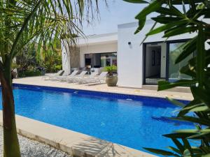 a villa with a swimming pool and lounge chairs at Moraira B5 in Moraira