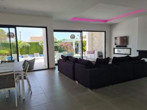 a living room with a couch and a table and chairs at Moraira B5 in Moraira