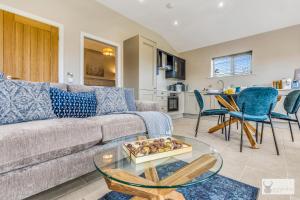 a living room with a couch and a table at Silver Stag Properties, 1 BR Slate Lodge 