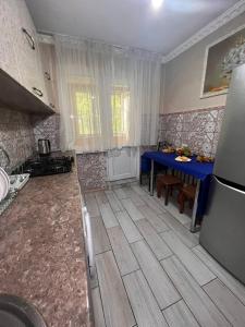 a kitchen with a blue table and a blue table and a blue tableablish at 15 Apartments in Shymkent