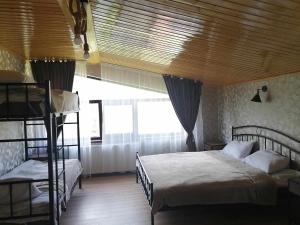 a bedroom with two bunk beds and a large window at Garemta in Stepantsminda