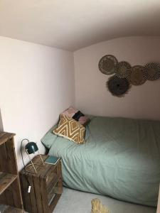 a bedroom with a green bed and some decorations on the wall at Beautiful, well positioned flat in Clifton Wood in Bristol