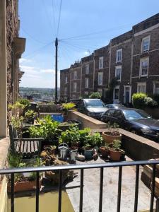 a balcony with a bunch of potted plants on it at Beautiful, well positioned flat in Clifton Wood in Bristol