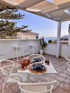 a patio with a table and chairs on a balcony at Don Carlo Tropea in Tropea
