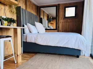 a bedroom with a bed in a wooden wall at The Bachelor in Mossel Bay