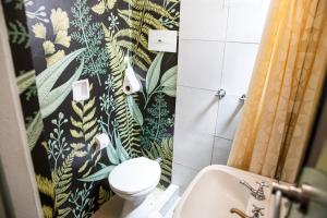 a bathroom with a toilet and a sink at Art Factory Soho in Buenos Aires