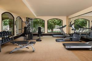 a gym with several treadmills and elliptical machines at Jaz Oriental, Almaza Bay in Marsa Matruh