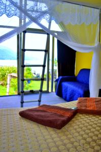 a bedroom with a bed and a rug and a ladder at Mundo Abu San Juan La laguna in San Juan La Laguna