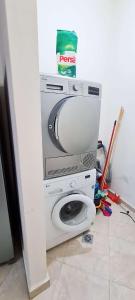 a washer and dryer in a corner of a room at CityCenter Charm in Ramallah