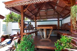 a wooden table and bench under a wooden umbrella at 5 Bedroom Villa in Fisherman’s Village in Bophut 
