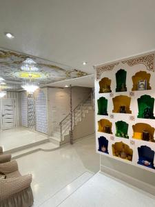 a room with a wall with yellow and green shelves at мртапрапвак in Bukhara