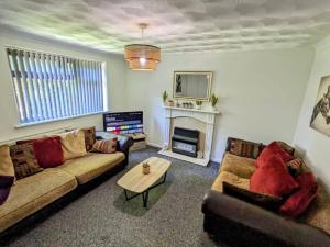 a living room with two couches and a fireplace at Hs UK Homes Beautiful 2 bed in Bradford in Bradford