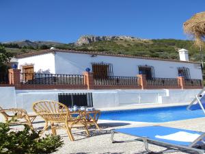 a villa with a swimming pool and a house at Casa Pilar in Canillas de Aceituno