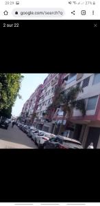 a picture of a street with cars parked in front of buildings at Mohammedia Nassim résidence Galia 