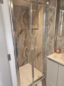 a shower with a glass door in a bathroom at Carlisle City Centre. The Foremans Residence. in Carlisle