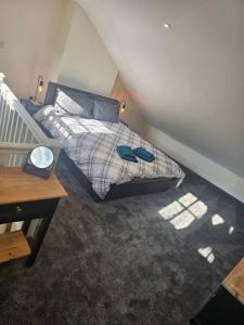 1 dormitorio con 1 cama con zapatillas azules en Carlisle City Centre. The Foremans Residence. en Carlisle