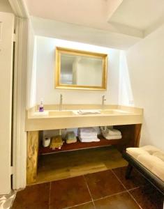a bathroom with a sink and a mirror at Your cozy home @Rosarito in Rosarito