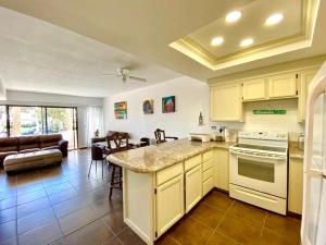 a kitchen and living room with a stove top oven at Your cozy home @Rosarito in Rosarito