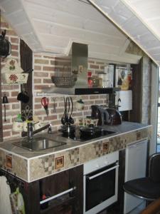 a kitchen with a sink and a counter top at MaaRitza Holiday Cottage in Türi