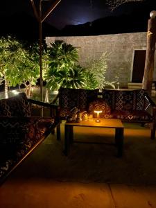 a living room with a table with a candle on it at Mountain house in Al-ʿUla