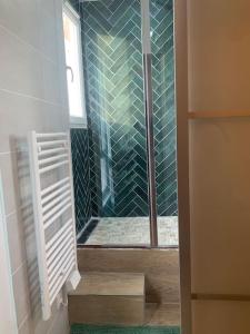 a shower with a glass door in a bathroom at Aubervilliers Paris in Aubervilliers +11 photos
