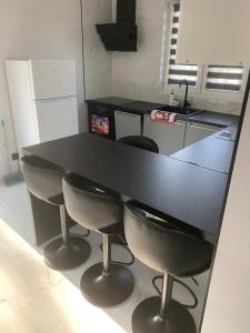 a kitchen with a black table and four chairs at Biebrzańska Przystań in Goniadz