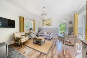 a living room with a couch and a table at Stable Cottage in Dorchester