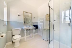 a bathroom with a toilet and a sink and a shower at Stable Cottage in Dorchester +21 photos