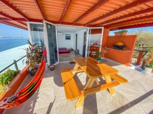 a hammock and a wooden table on a patio at Malibu Rooftop in Nueva Gorgona