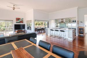 a living room with a couch and a table at Cantley at Flutes Estate, Margaret River in Wilyabrup