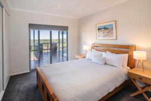 a bedroom with a large bed and a balcony at Cantley at Flutes Estate, Margaret River in Wilyabrup