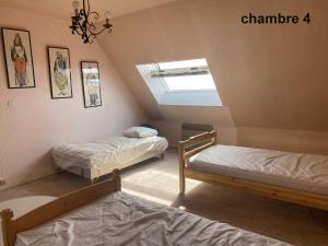 a attic bedroom with two beds and a skylight at gavres-port-louis-ocean in Gâvres