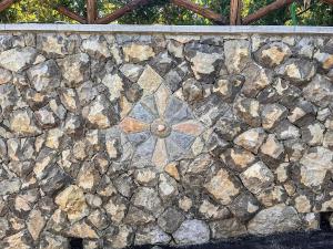 a stone wall with a stone flower on it at Casa Vacanze Chery in Sorrento