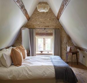 a bedroom with a large bed in a attic at Dawn at The Sun Inn Felmersham, Our Signature Duplex Suite in Sharnbrook