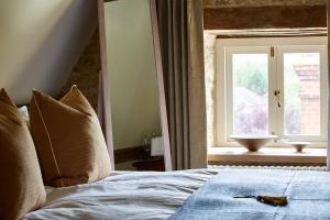 a bedroom with a bed and a window with a bowl at Dawn at The Sun Inn Felmersham, Our Signature Duplex Suite in Sharnbrook