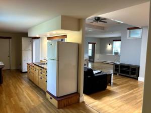 a kitchen and living room with a refrigerator at Spacious Medford Gem in Medford