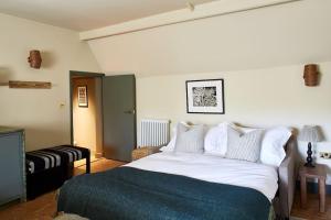 a bedroom with a large bed with white sheets and pillows at Dawn at The Sun Inn Felmersham, Our Signature Duplex Suite in Sharnbrook