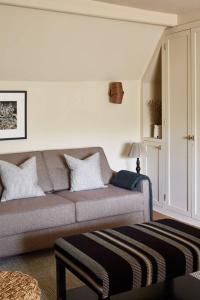 a living room with a couch and a table at Dawn at The Sun Inn Felmersham, Our Signature Duplex Suite in Sharnbrook