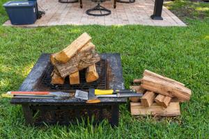 a grill with a bunch of logs and a bunch at Cozy Place in Miami