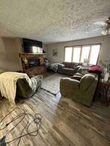 a living room with a couch and a fireplace at A great house by Fonner Park in Grand Island