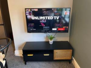 a flat screen tv sitting on a wall at Luxury 1 bed Flat + sofa bed- Dudley 