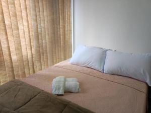 ein Bett mit zwei Handtüchern darauf in der Unterkunft Apartamento Curitiba Palace in Curitiba