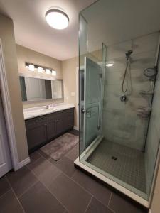 bagno con doccia in vetro e lavandino di 4 BD Family Retreat a Stratford